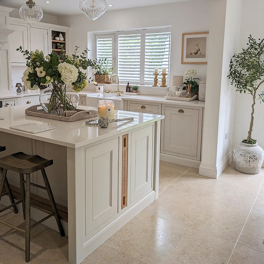 Polished beige limestone-effect kitchen floor tiles